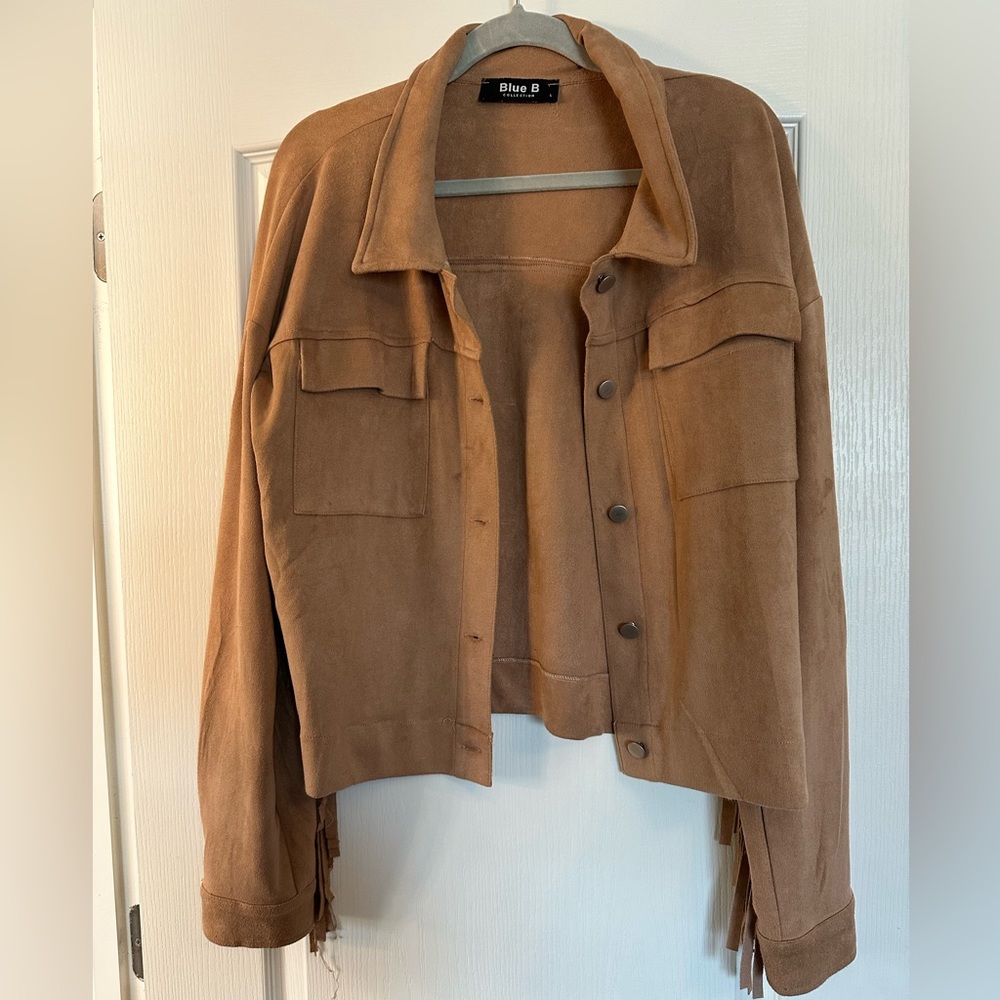 Faux suede beige jacket with fringe.